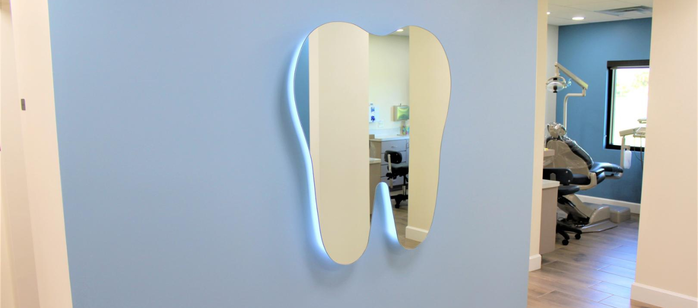 Tooth shaped mirror on wall of Melbourne dental office