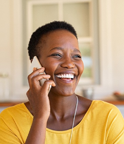 Woman smiling while talking on phone