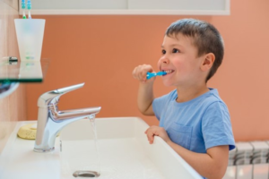 a child brushing his teeth